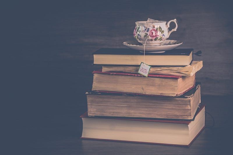A teacup placed on a pile of books
